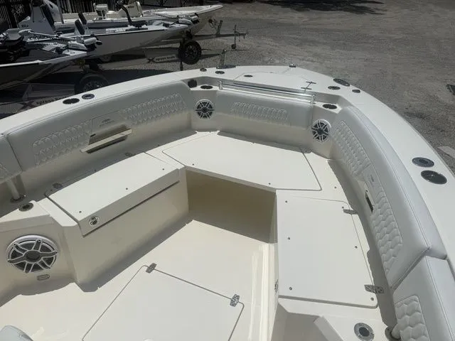 Slide: The Image of The image shows the bow area of a 2025 Cobia 265 Open Center Console boat with cushioned seating and speakers. - 11
