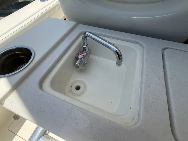 Slide: The Image of A sink with a faucet on a boat, surrounded by a countertop. - 24