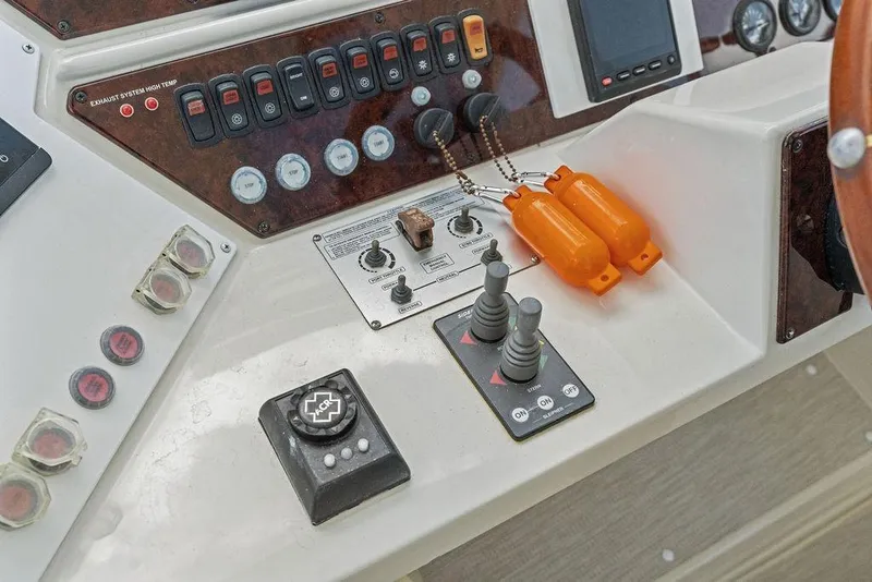 Slide: The Image of Control panel of a 2005 Marquis 65 MY yacht with switches and joysticks. - 61