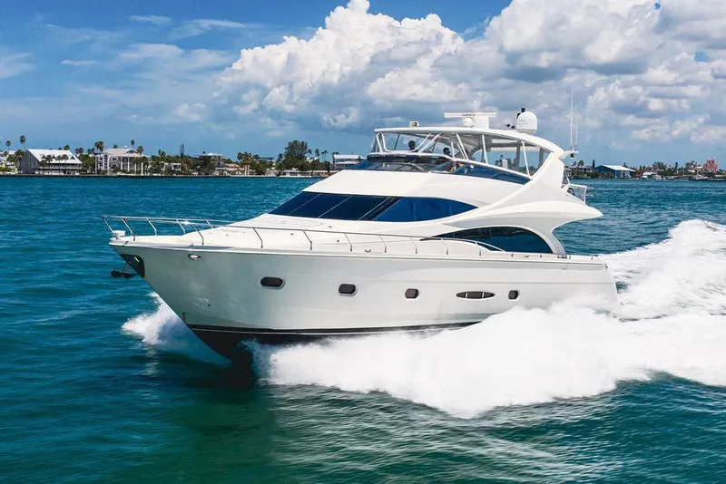 Slide: The Image of Luxurious 2005 Marquis 65 MY yacht cruising on clear blue waters under a sunny sky. - 9