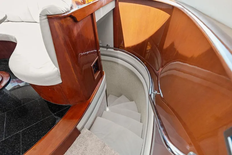 Slide: The Image of Luxurious wooden staircase inside a 2005 Marquis 65 MY yacht, featuring elegant design. - 18
