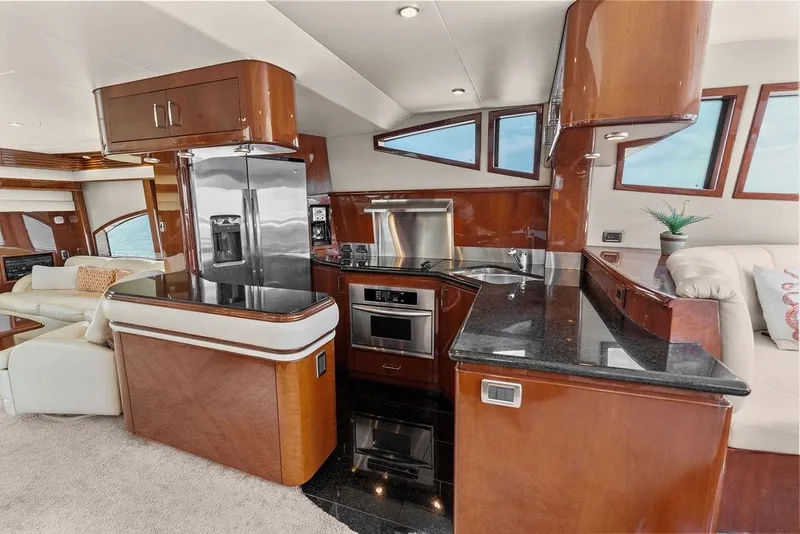 Slide: The Image of Luxurious 2005 Marquis 65 MY yacht kitchen with modern appliances and elegant wood finishes. - 71