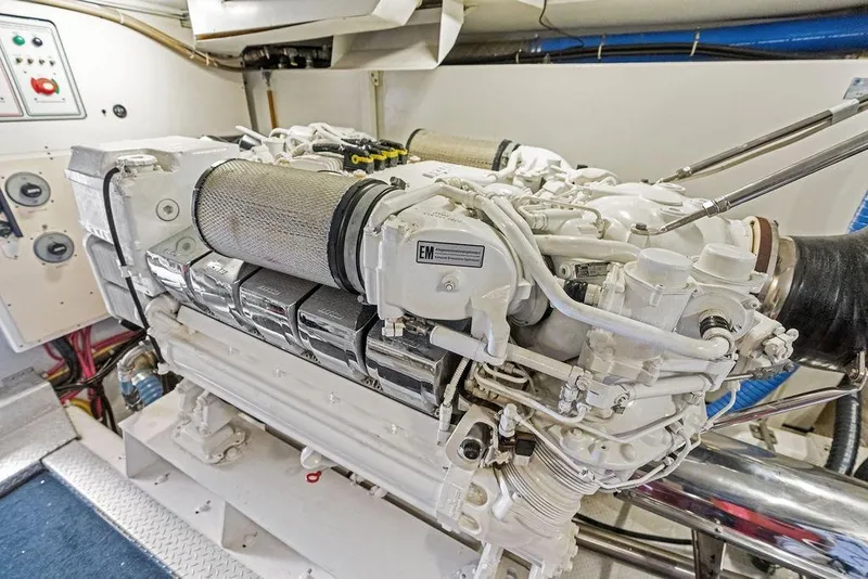 Slide: The Image of Engine room of a 2005 Marquis 65 MY yacht, showcasing a powerful marine engine. - 85
