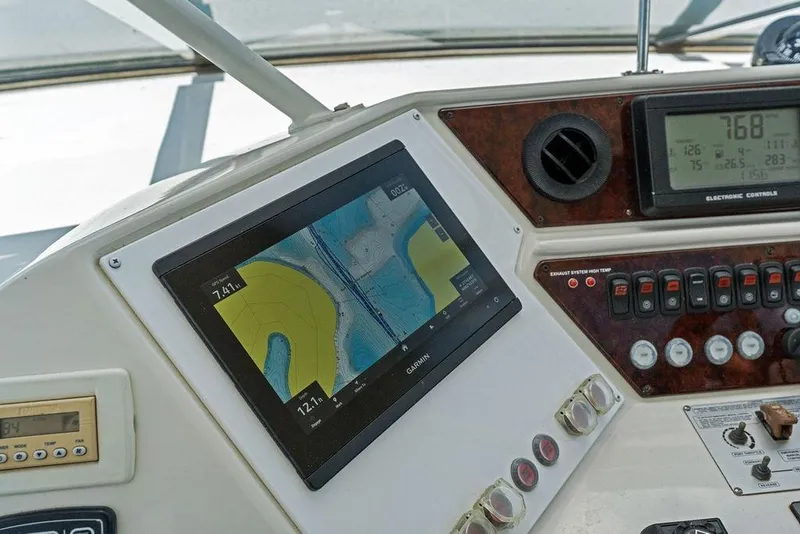Slide: The Image of Control panel of a 2005 Marquis 65 MY yacht with navigation and electronic controls. - 60