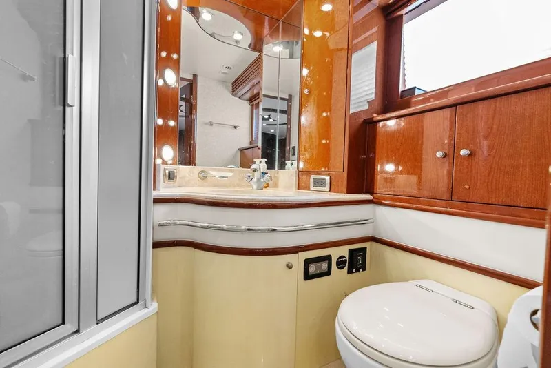 Slide: The Image of Luxurious bathroom in 2005 Marquis 65 MY yacht with wood cabinetry and modern fixtures. - 32