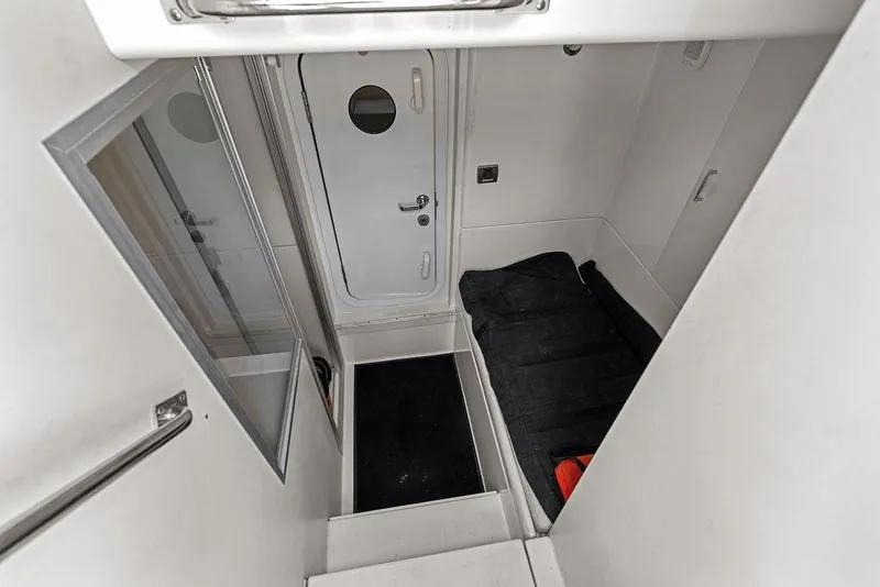 Slide: The Image of Interior view of 2005 Marquis 65 MY yacht, featuring sleek white walls and a secure door. - 83