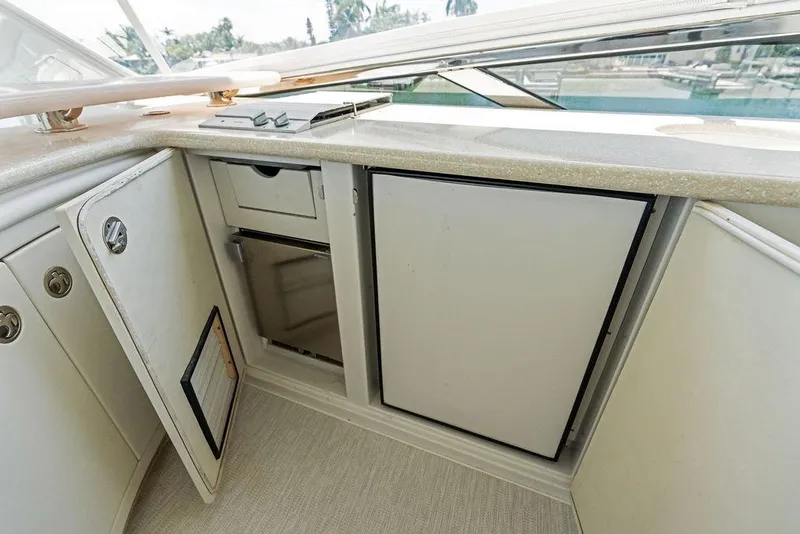 Slide: The Image of 2005 Marquis 65 MY yacht interior with open storage compartments and countertop. - 55