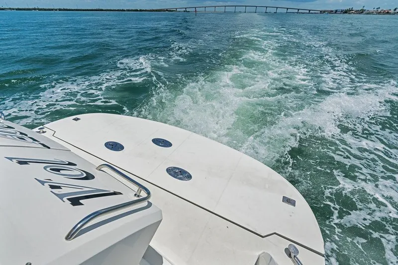 Slide: The Image of 2005 Marquis 65 MY yacht cruising on open water with bridge in background. - 38