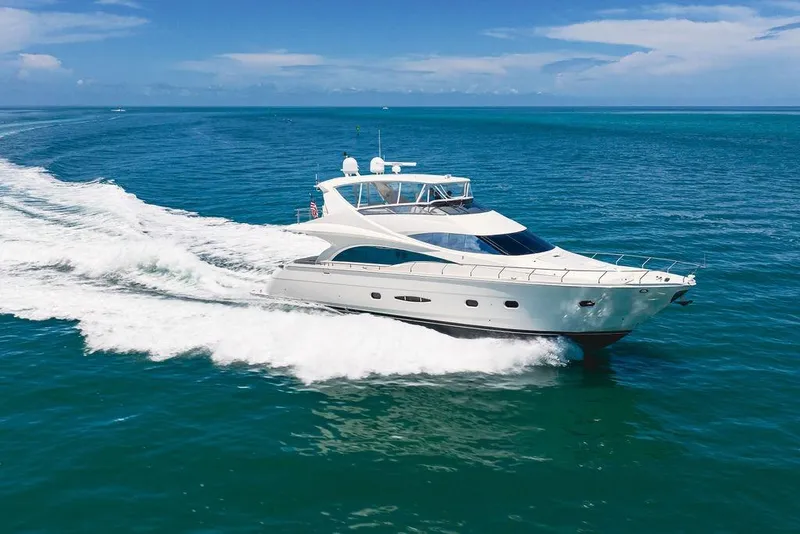 Slide: The Image of Luxury 2005 Marquis 65 MY yacht cruising on open blue ocean waters. - 14