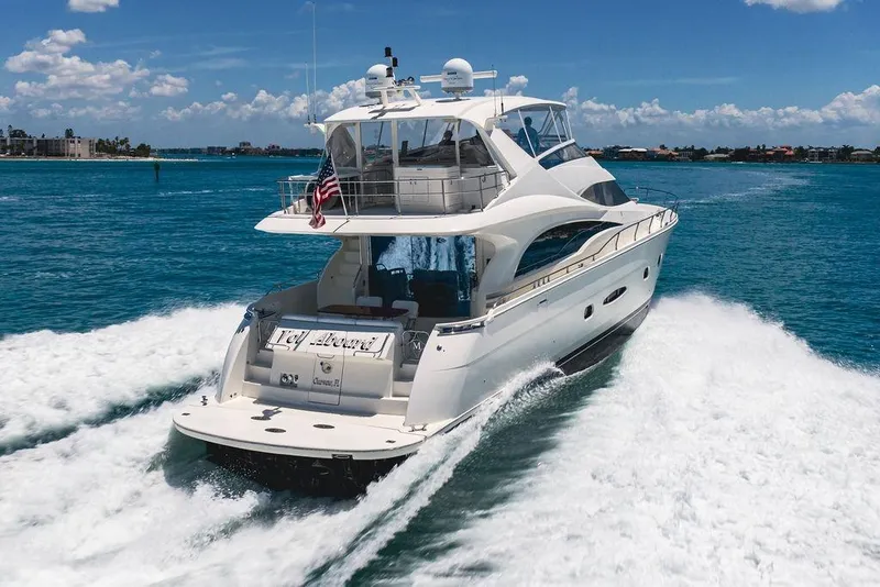 Slide: The Image of Luxury 2005 Marquis 65 MY yacht cruising on clear blue waters. - 10