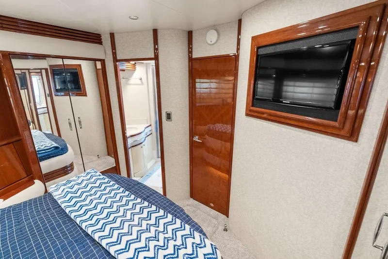 Slide: The Image of Luxurious 2005 Marquis 65 MY yacht bedroom with TV and elegant wood finishes. - 22