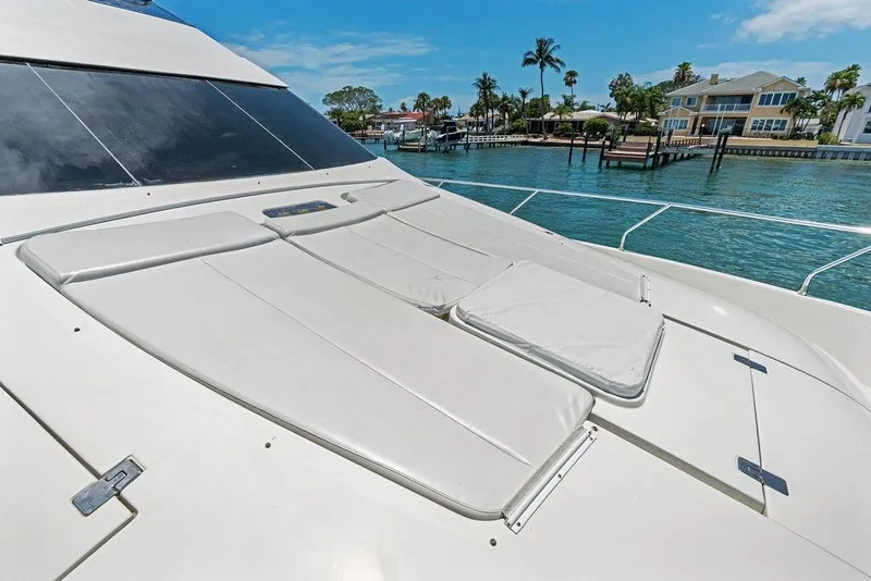 Slide: The Image of Luxury 2005 Marquis 65 MY yacht with sunbathing deck, docked near waterfront homes. - 44