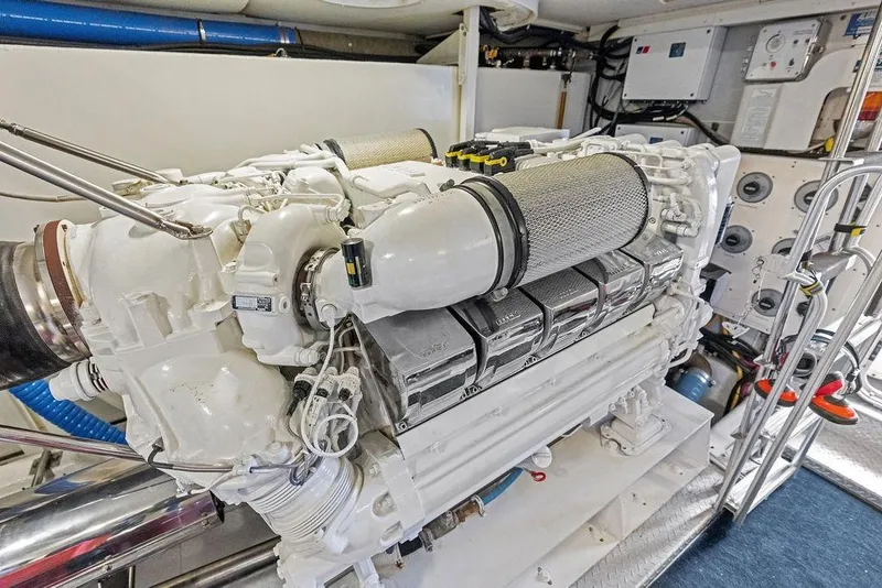 Slide: The Image of Engine room of a 2005 Marquis 65 MY yacht, showcasing a powerful marine engine. - 86