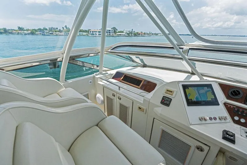 Slide: The Image of Luxurious 2005 Marquis 65 MY yacht cockpit with navigation system, overlooking serene waters. - 58