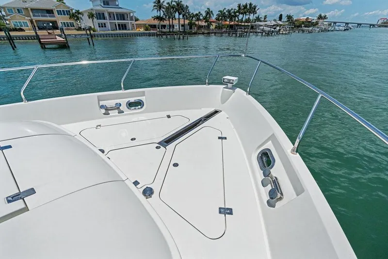 Slide: The Image of Bow view of 2005 Marquis 65 MY yacht, docked near waterfront homes. - 43