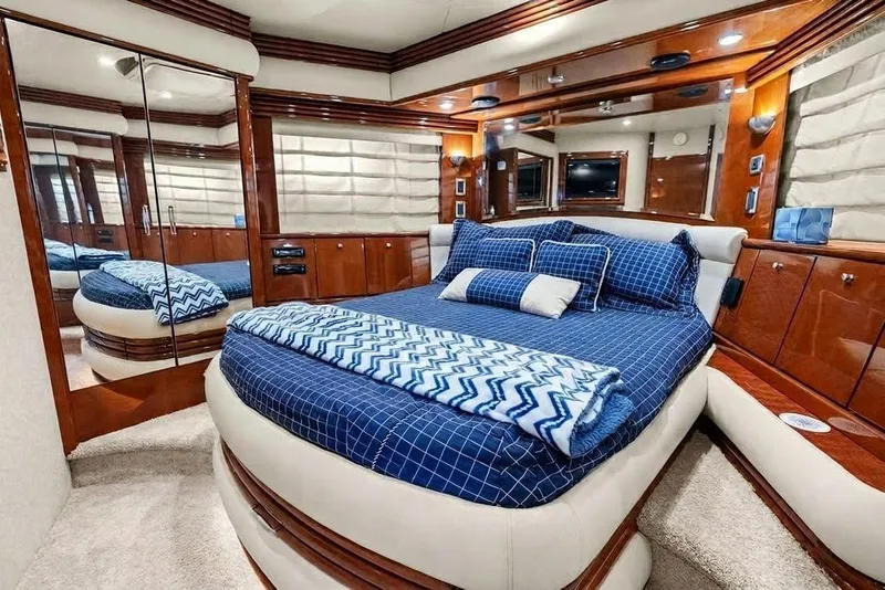 Slide: The Image of Luxurious bedroom interior of 2005 Marquis 65 Motor Yacht with blue bedding and wood accents. - 21