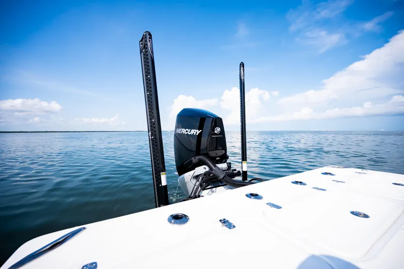 Slide: The Image of 2023 Canyon Bay 28h boat with Mercury engine on calm water under blue sky. - 48