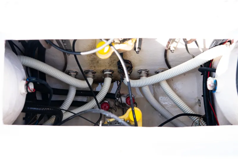 Slide: The Image of Engine compartment of 2023 Canyon Bay 28h boat with visible hoses and wiring. - 51