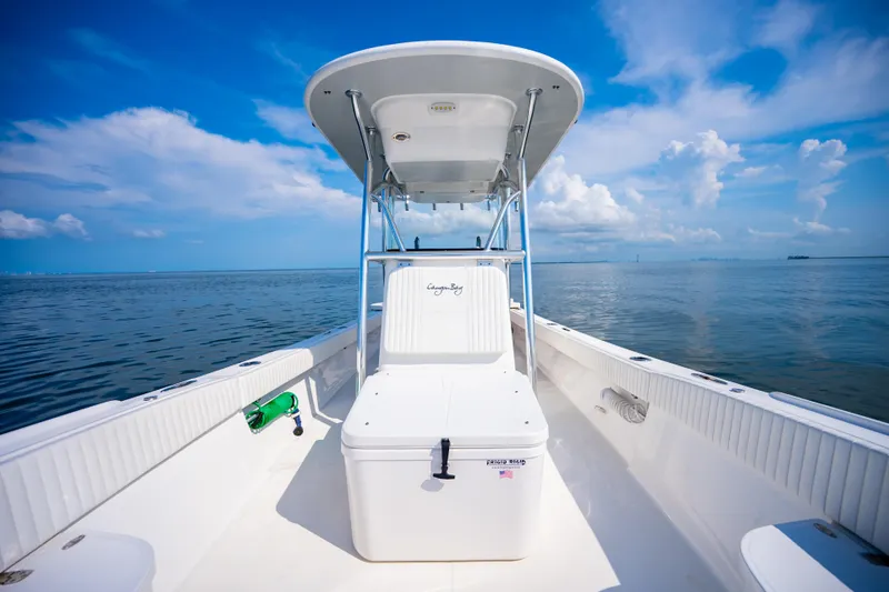 Slide: The Image of 2023 Canyon Bay 28h boat on calm ocean under blue sky. - 18