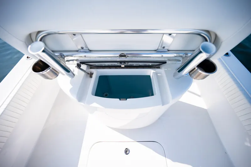 Slide: The Image of 2023 Canyon Bay 28h boat interior with rod holders and storage compartment. - 36