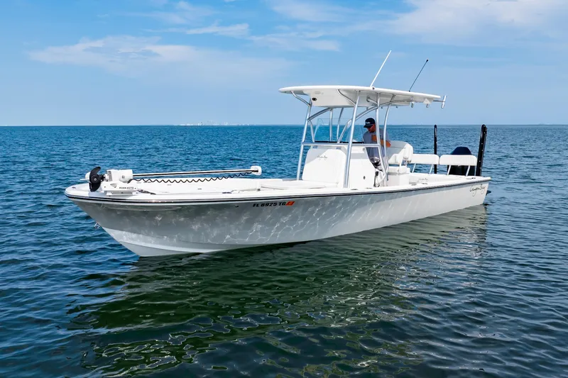 Slide: The Image of 2023 Canyon Bay 28h boat on calm ocean waters under a clear blue sky. - 4