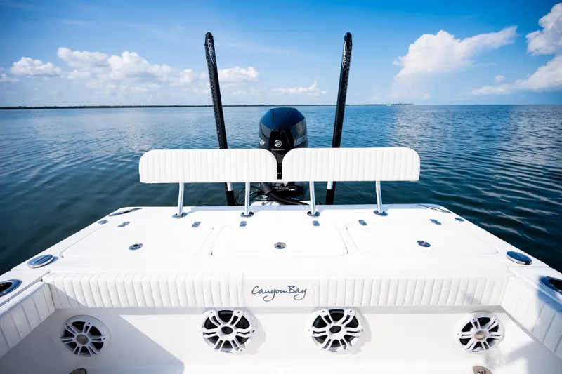 Slide: The Image of 2023 Canyon Bay 28h boat on calm water, featuring a sleek design and powerful engine. - 47