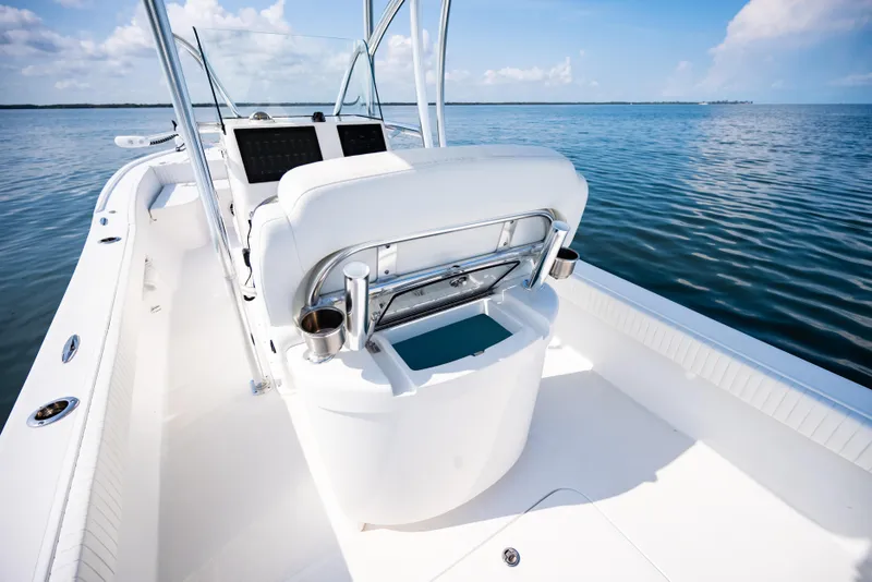 Slide: The Image of 2023 Canyon Bay 28h boat interior with sleek white seating and ocean view. - 32