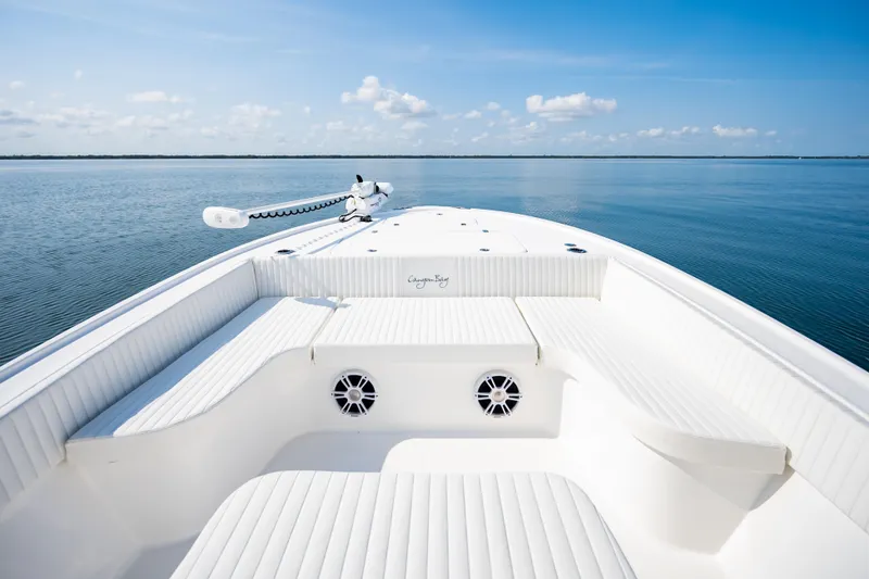 Slide: The Image of 2023 Canyon Bay 28h boat interior with white seating on calm water. - 17