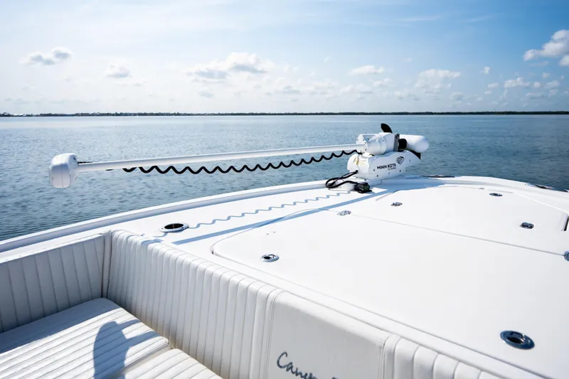 Slide: The Image of Canyon Bay 28h boat deck with trolling motor, 2023 model, on calm water. - 11