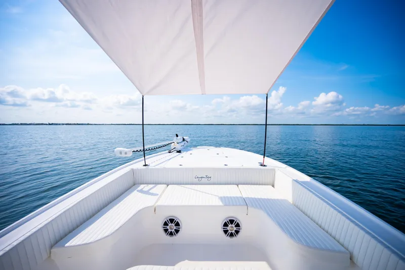 Slide: The Image of 2023 Canyon Bay 28h boat on calm ocean under clear blue sky. - 21