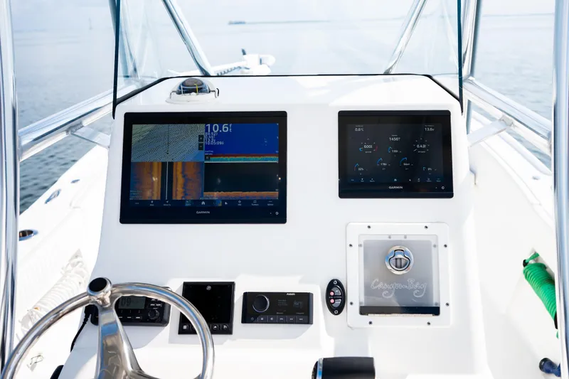 Slide: The Image of Canyon Bay 28h 2023 boat dashboard with dual Garmin displays and steering wheel. - 29