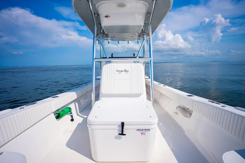 Slide: The Image of 2023 Canyon Bay 28h boat on calm ocean under blue sky. - 25