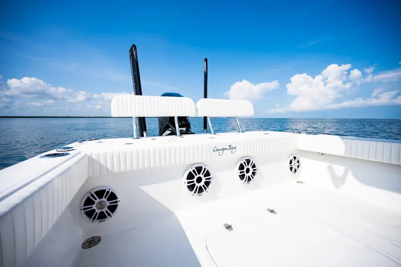 Slide: The Image of 2023 Canyon Bay 28h boat interior with speakers, on a sunny day at sea. - 42