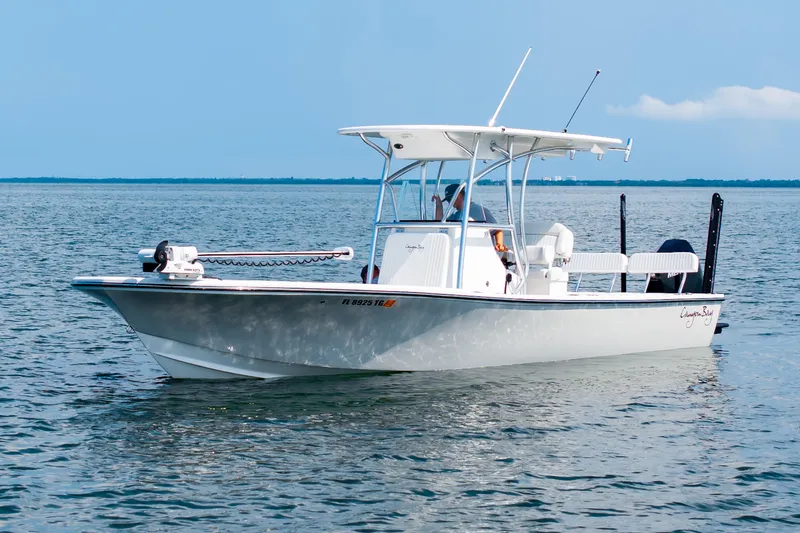 Slide: The Image of 2023 Canyon Bay 28h boat on calm water under clear blue sky. - 9