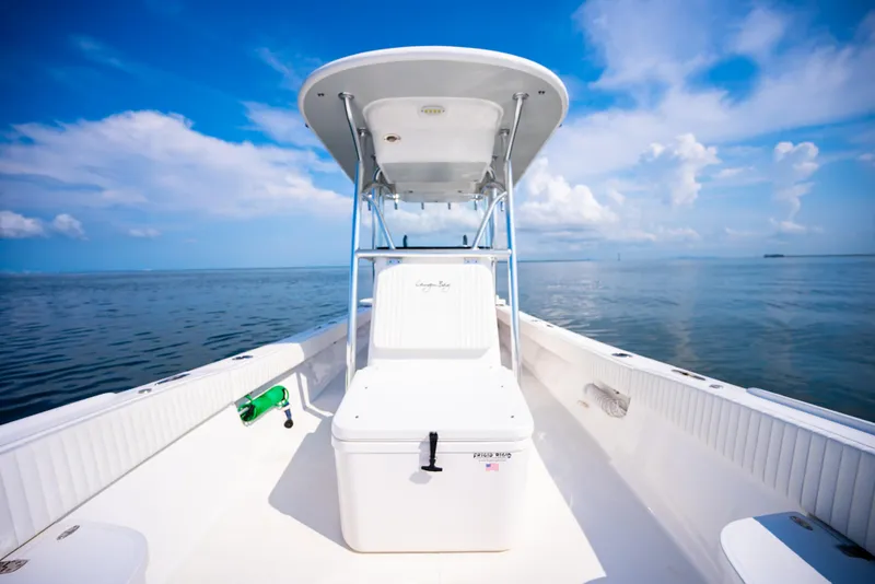 Slide: The Image of 2023 Canyon Bay 28h boat on calm ocean under clear blue sky. - 26