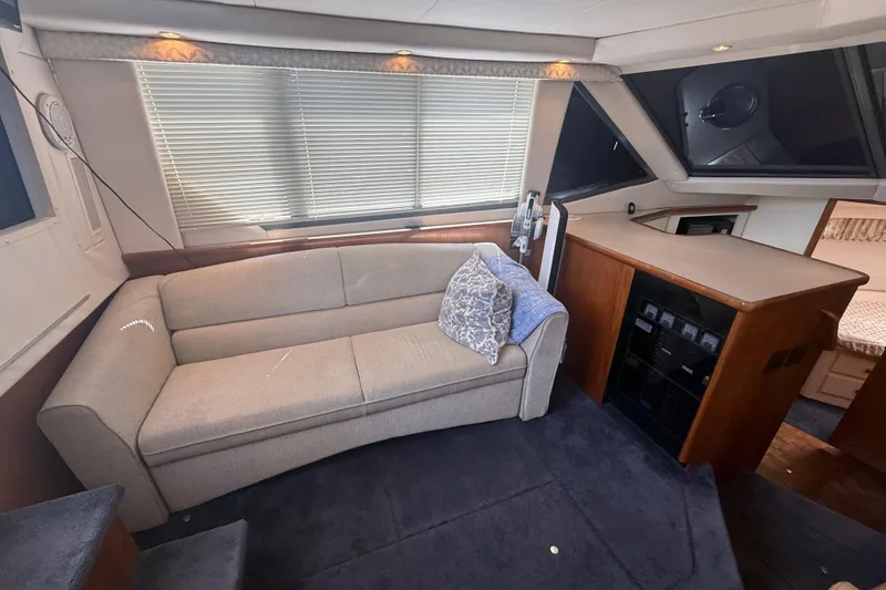 Slide: The Image of Interior of 1996 Carver 400 Cockpit Motor Yacht with sofa and cabin area. - 29