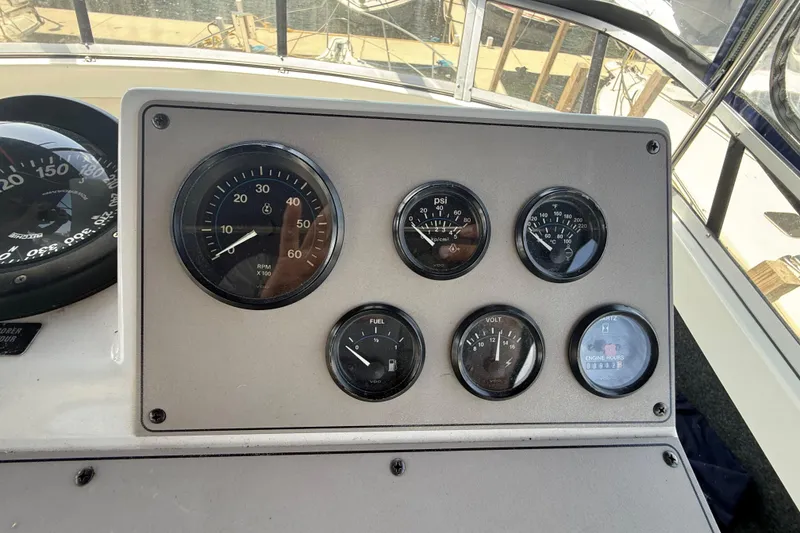Slide: The Image of Instrument panel of a 1996 Carver 400 Cockpit Motor Yacht with various gauges. - 27