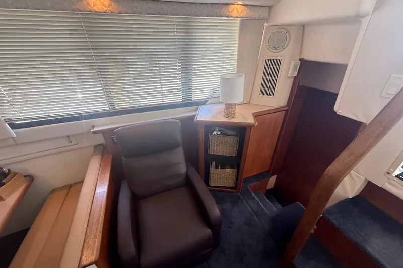 Slide: The Image of Interior of 1996 Carver 400 Cockpit Motor Yacht with chair, lamp, and storage baskets. - 30