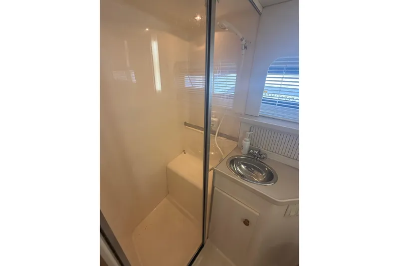 Slide: The Image of Bathroom interior of 1996 Carver 400 Cockpit Motor Yacht with shower and sink. - 43