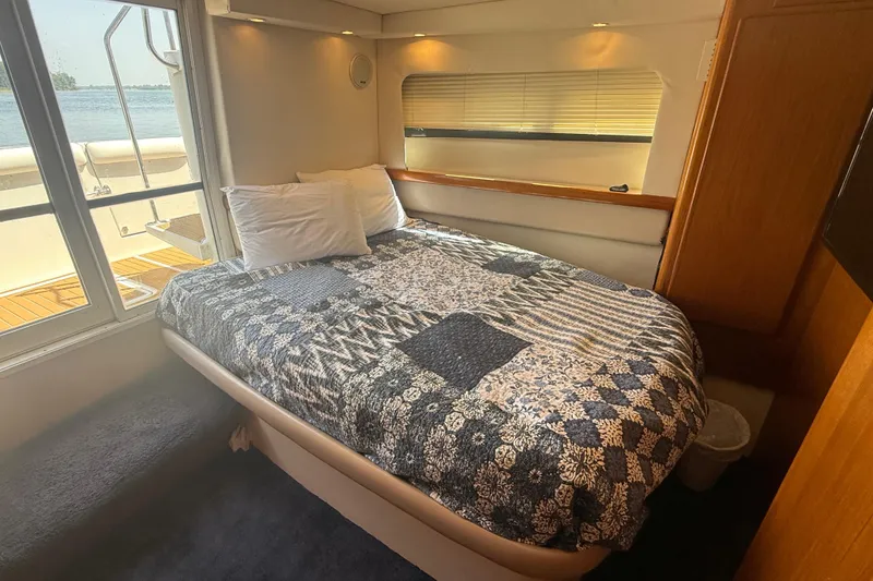 Slide: The Image of Cozy bedroom in 1996 Carver 400 Cockpit Motor Yacht with scenic window view. - 41