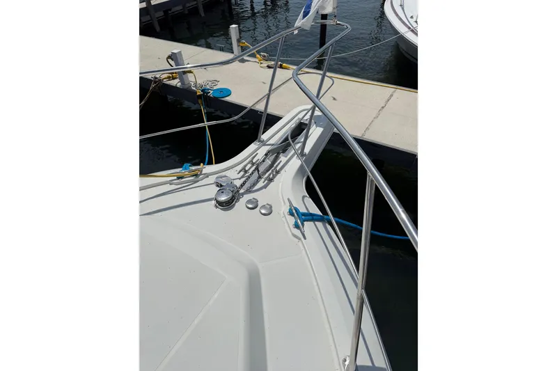 Slide: The Image of Bow view of 1996 Carver 400 Cockpit Motor Yacht docked at marina. - 7