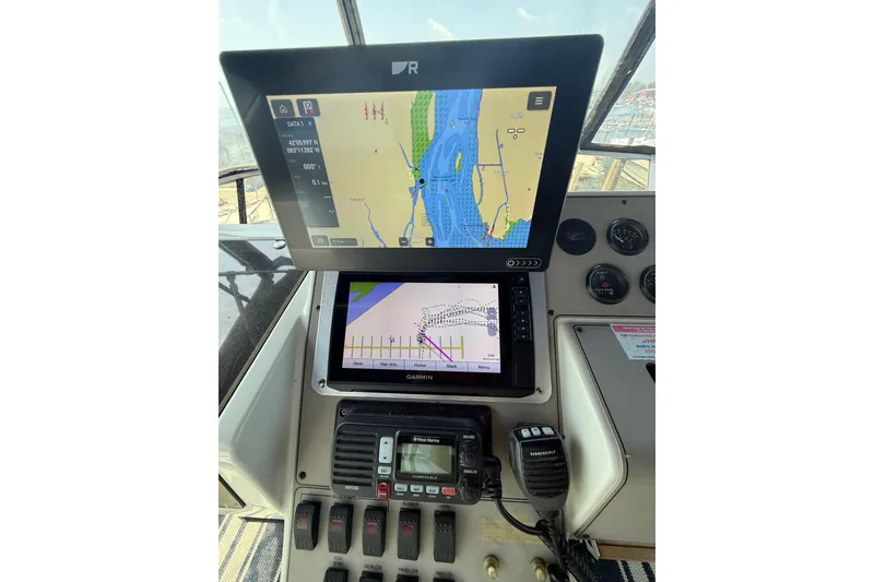 Slide: The Image of Navigation system on 1996 Carver 400 Cockpit Motor Yacht dashboard, featuring dual screens and controls. - 24