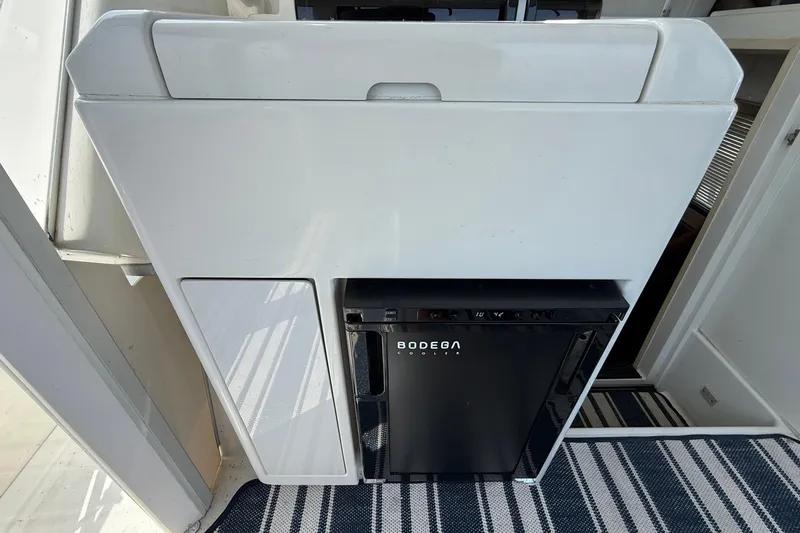 Slide: The Image of Interior of 1996 Carver 400 Cockpit Motor Yacht with compact Bodega cooler. - 16