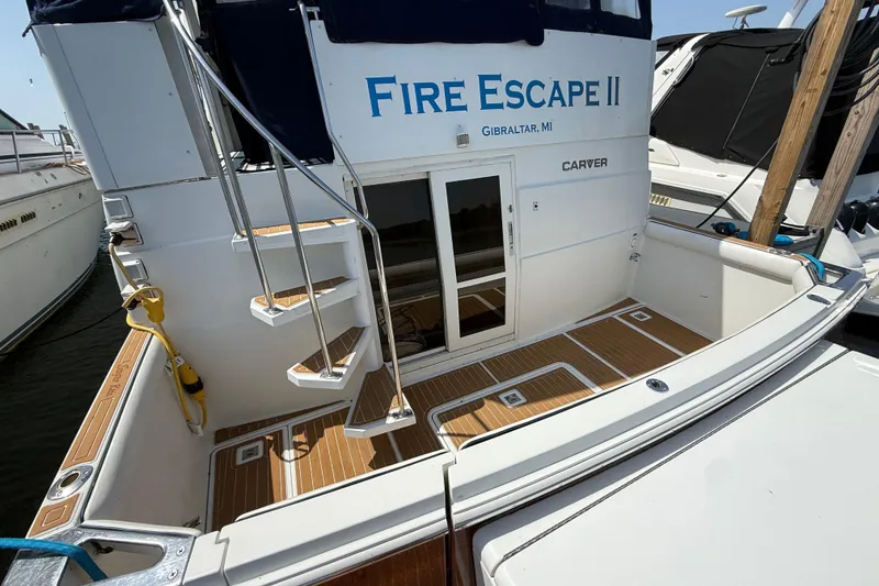 Slide: The Image of 1996 Carver 400 Cockpit Motor Yacht docked, featuring teak flooring and rear entry. - 11