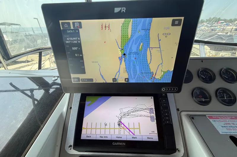 Slide: The Image of Navigation screens on a 1996 Carver 400 Cockpit Motor Yacht dashboard. - 23