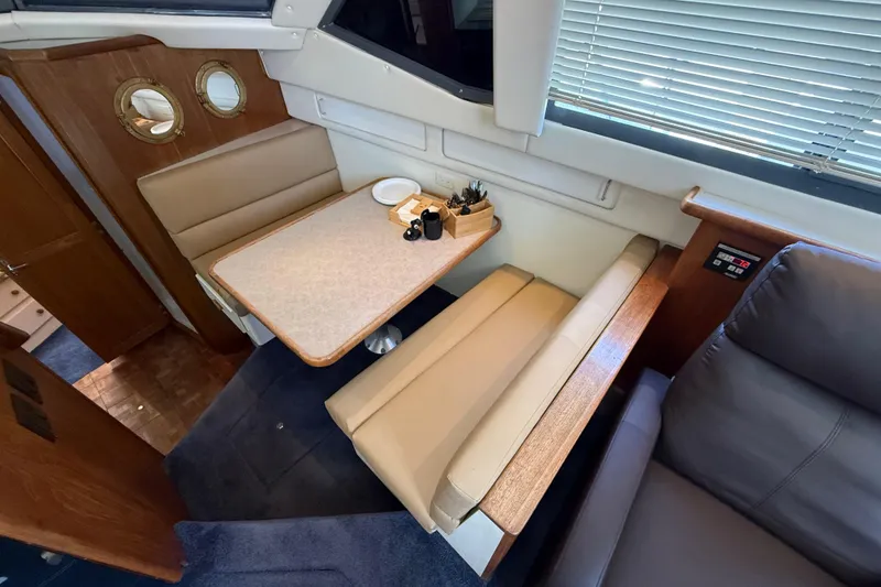 Slide: The Image of Interior of 1996 Carver 400 Cockpit Motor Yacht with dining area and seating. - 32
