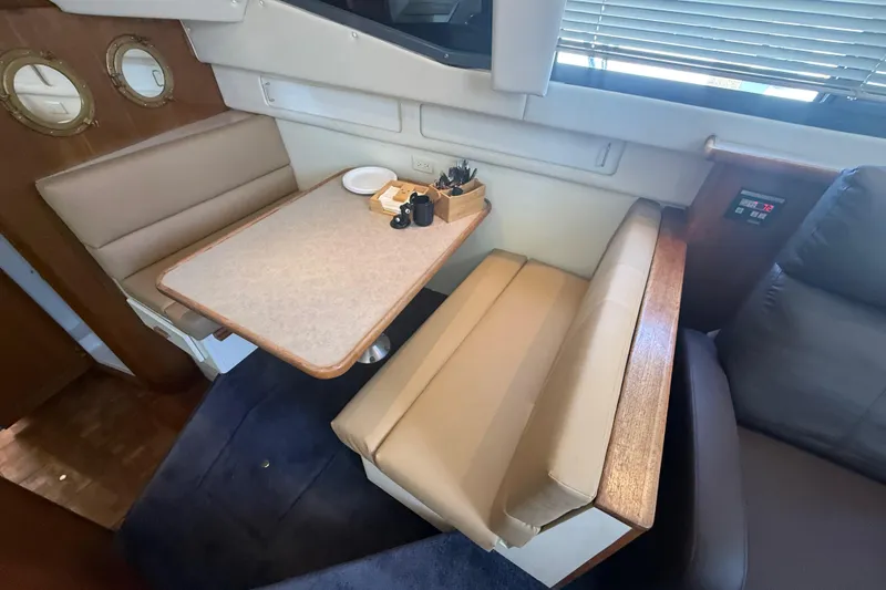 Slide: The Image of Interior of 1996 Carver 400 Cockpit Motor Yacht with dining area and seating. - 33