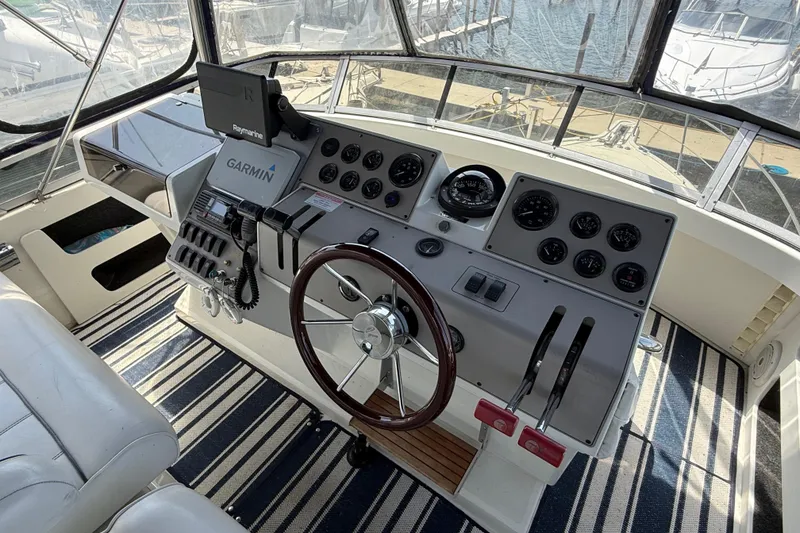Slide: The Image of Helm of 1996 Carver 400 Cockpit Motor Yacht with Garmin navigation system and striped flooring. - 19