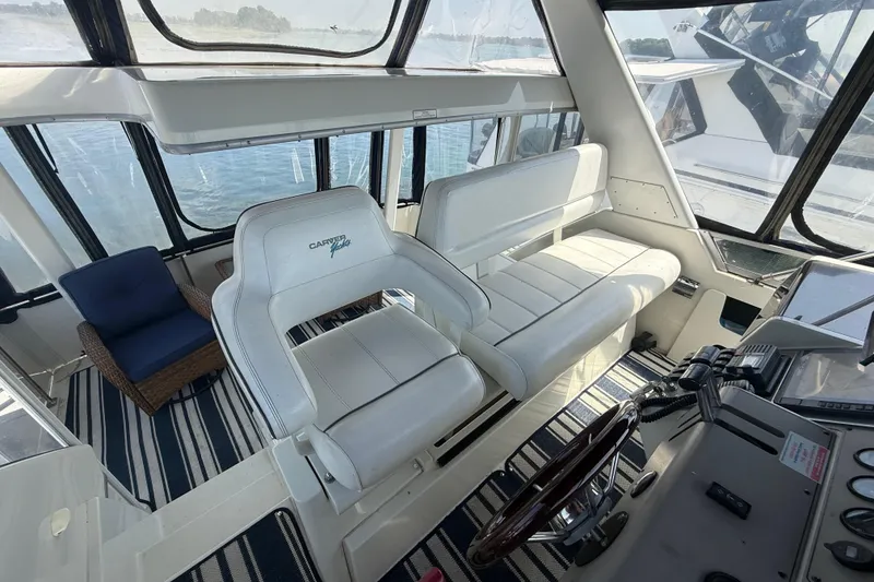 Slide: The Image of Interior of 1996 Carver 400 Cockpit Motor Yacht with white seating and striped flooring. - 22