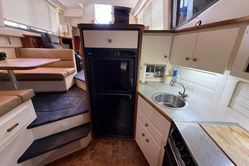 Slide: The Image of Interior of 1996 Carver 400 Cockpit Motor Yacht with kitchen and seating area. - 34